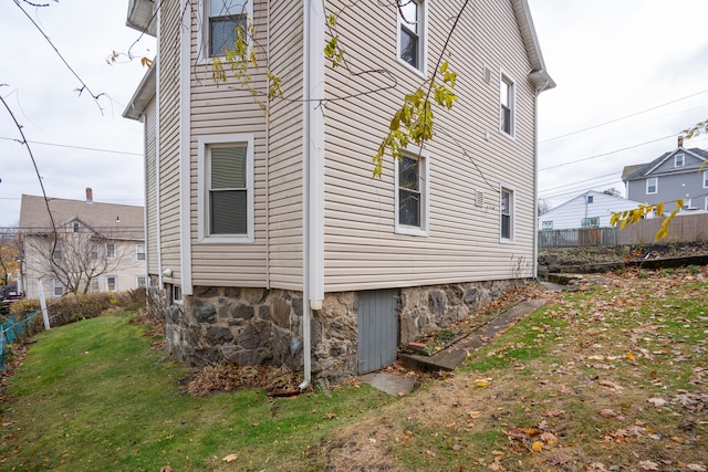 view of property exterior with a lawn