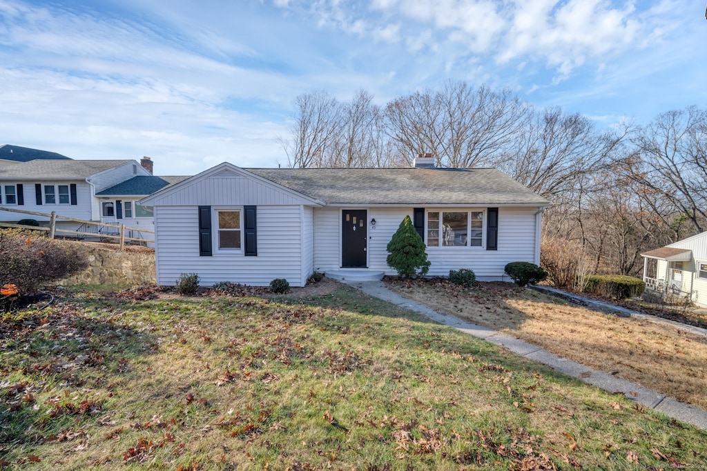 ranch-style home with a front lawn