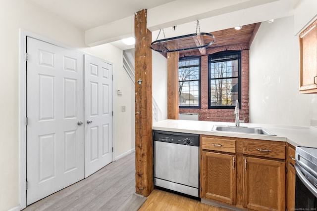 kitchen with appliances with stainless steel finishes, light hardwood / wood-style flooring, and sink