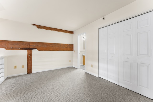 unfurnished bedroom featuring carpet flooring and a closet