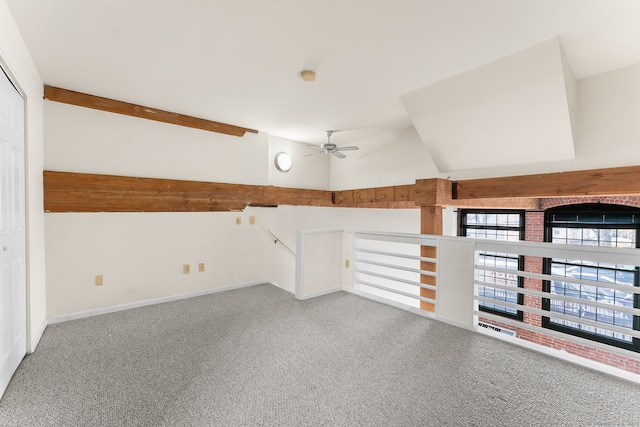 empty room featuring ceiling fan, carpet floors, and lofted ceiling