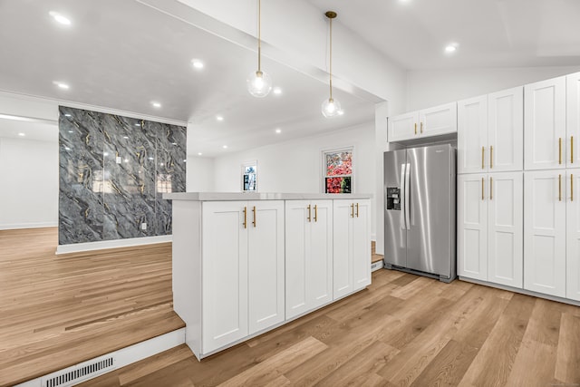 kitchen with white cabinets, stainless steel fridge with ice dispenser, light wood-type flooring, and pendant lighting