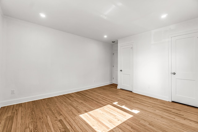 unfurnished room featuring light hardwood / wood-style floors and ornamental molding