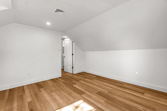 bonus room with light hardwood / wood-style flooring and lofted ceiling