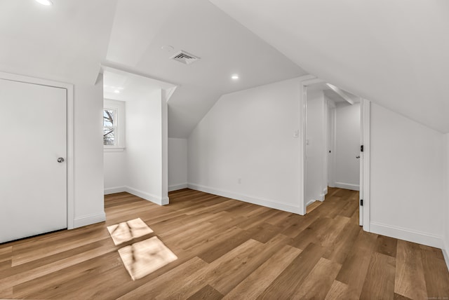 bonus room featuring light hardwood / wood-style floors and lofted ceiling