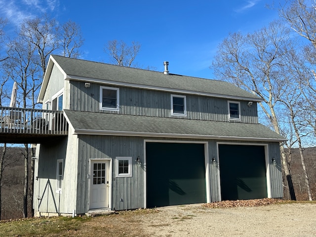 exterior space with a wooden deck and a garage