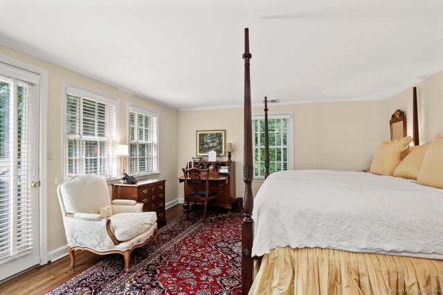 bedroom with access to outside, wood-type flooring, and ornamental molding