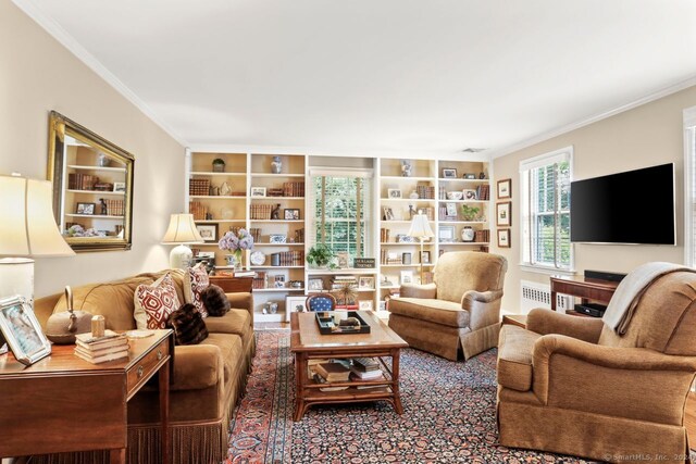 living room featuring crown molding and radiator heating unit