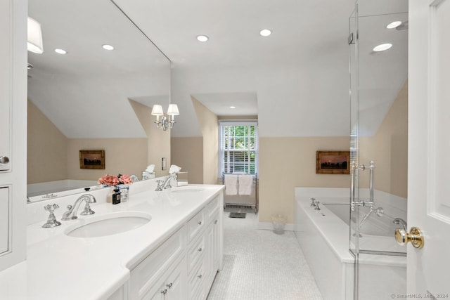 bathroom with a bathtub, vanity, and tile patterned flooring