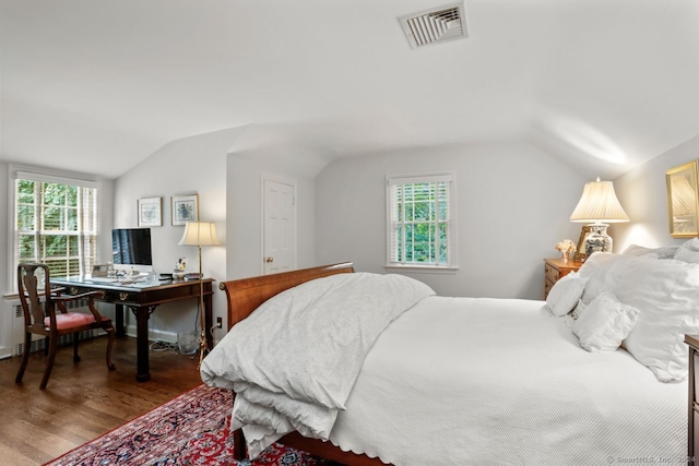 bedroom with radiator, wood-type flooring, and lofted ceiling