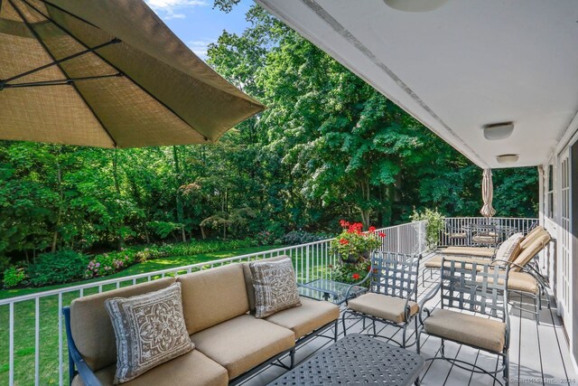 wooden terrace featuring an outdoor hangout area