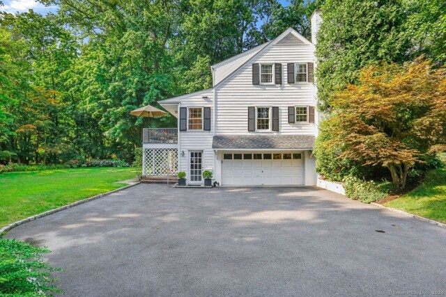 front facade featuring a garage and a front yard