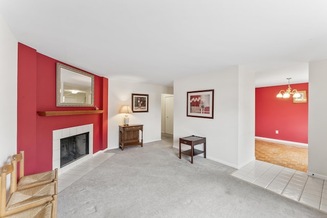 27 Crows Nest Ln Unit 15E, Danbury, CT 06810 - carpeted living room with a tiled fireplace, baseboards, tile patterned flooring, and a chandelier