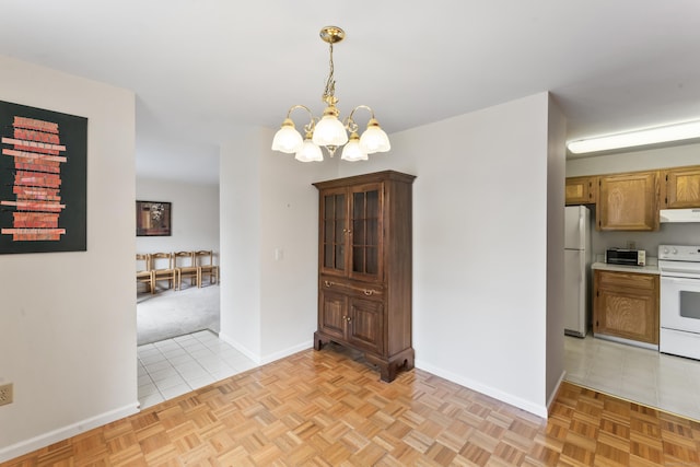 27 Crows Nest Ln Unit 15E, Danbury, CT 06810 - unfurnished dining area featuring a chandelier, baseboards, and light tile patterned floors