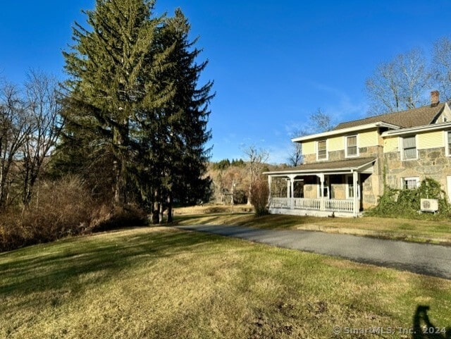 exterior space featuring a yard and a porch