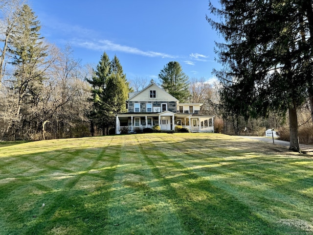 back of house with a lawn and a porch