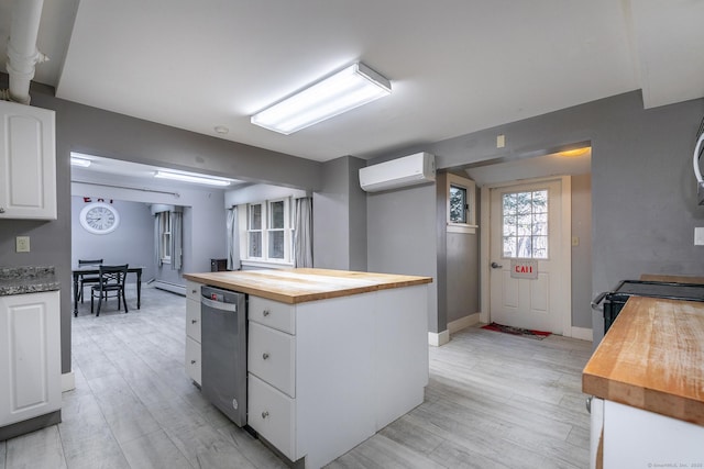 kitchen featuring wooden counters, black range with electric stovetop, a wall mounted air conditioner, white cabinetry, and light wood-type flooring