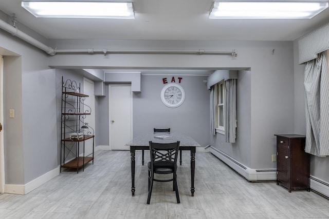 dining room featuring baseboards and light wood-style floors