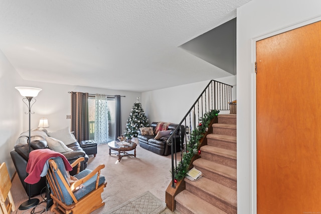 carpeted living room featuring a textured ceiling