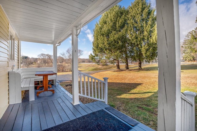 deck featuring a porch and a lawn