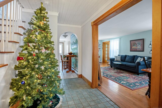 hallway featuring wooden ceiling, hardwood / wood-style flooring, a baseboard radiator, and ornamental molding