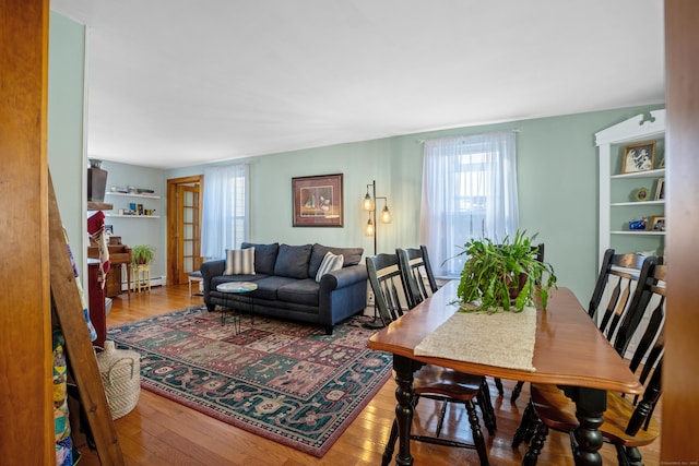 dining area featuring wood-type flooring and baseboard heating