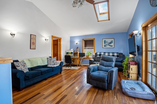 living room with a skylight, ceiling fan, high vaulted ceiling, and hardwood / wood-style flooring