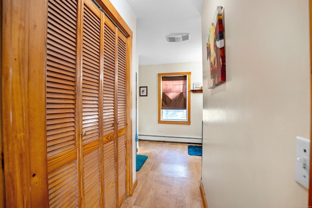 hall featuring light wood-type flooring and a baseboard radiator