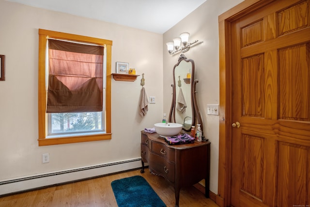 interior space with light wood-type flooring and a baseboard radiator