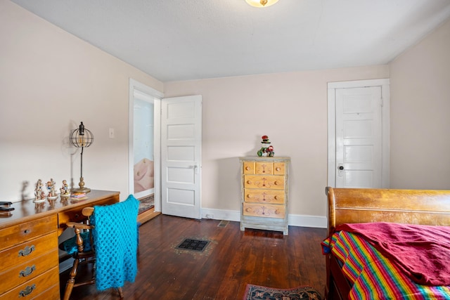 bedroom with dark hardwood / wood-style flooring