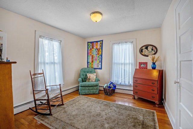 living area featuring hardwood / wood-style floors and a textured ceiling