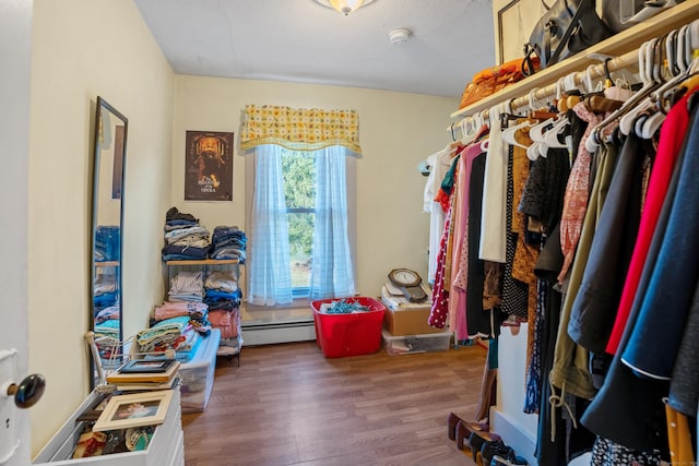 walk in closet with baseboard heating and hardwood / wood-style flooring