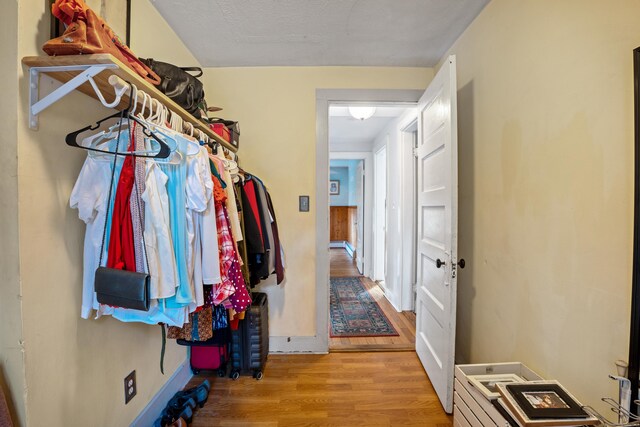 spacious closet featuring light hardwood / wood-style floors