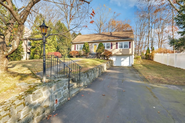 ranch-style house with a garage and a front yard