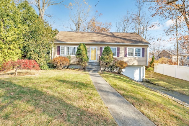 view of front of home featuring a garage and a front yard