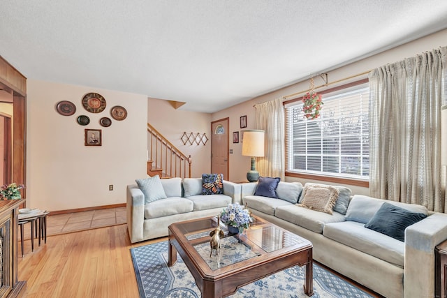 living room featuring light hardwood / wood-style floors and a textured ceiling