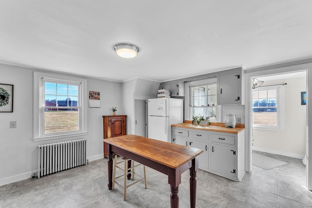 office area with radiator heating unit and crown molding