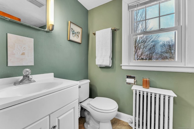 bathroom featuring radiator heating unit, vanity, and toilet