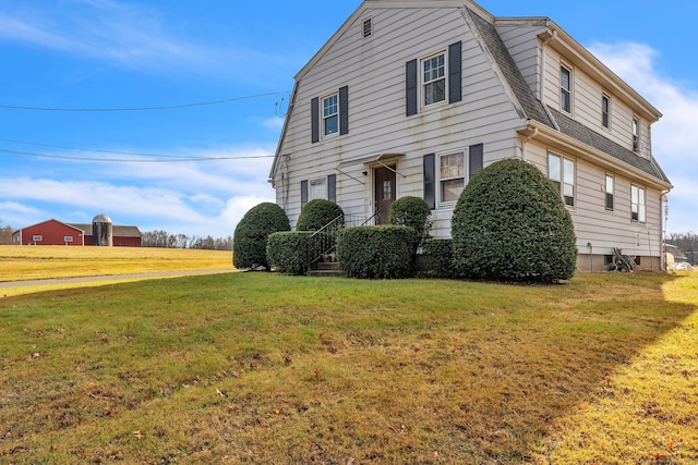 view of side of home with a lawn