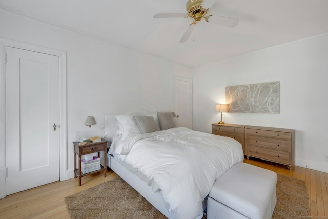 bedroom with light hardwood / wood-style flooring and ceiling fan