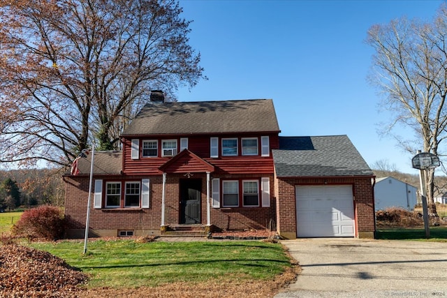 view of front of house with a garage and a front yard