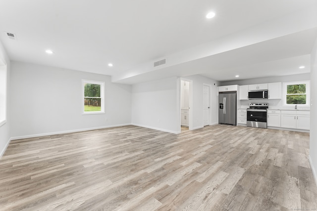 unfurnished living room with light hardwood / wood-style floors