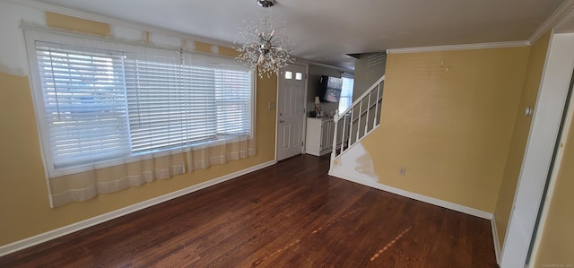 foyer entrance with ornamental molding and dark wood-type flooring