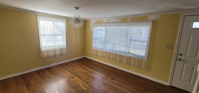 foyer featuring ornamental molding, dark hardwood / wood-style floors, and a notable chandelier