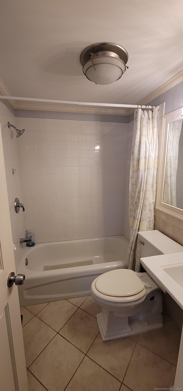 bathroom featuring tile patterned flooring, ornamental molding, shower / bath combo, and toilet