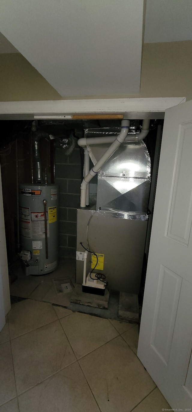 utility room with heating unit and gas water heater