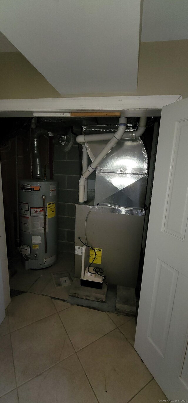 utility room featuring gas water heater and heating unit