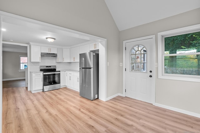 kitchen with a wealth of natural light, white cabinetry, light hardwood / wood-style flooring, and appliances with stainless steel finishes