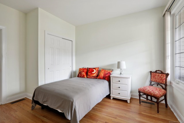 bedroom featuring light hardwood / wood-style floors and a closet