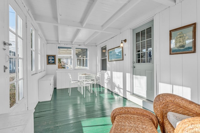 sunroom / solarium with beamed ceiling and radiator